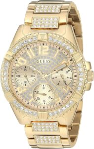 GUESS Gold-Tone Stainless Steel Crystal Watch with Day, Date + 24 Hour Military/Int’l Time. Color: Gold-Tone (Model: U1156L2)